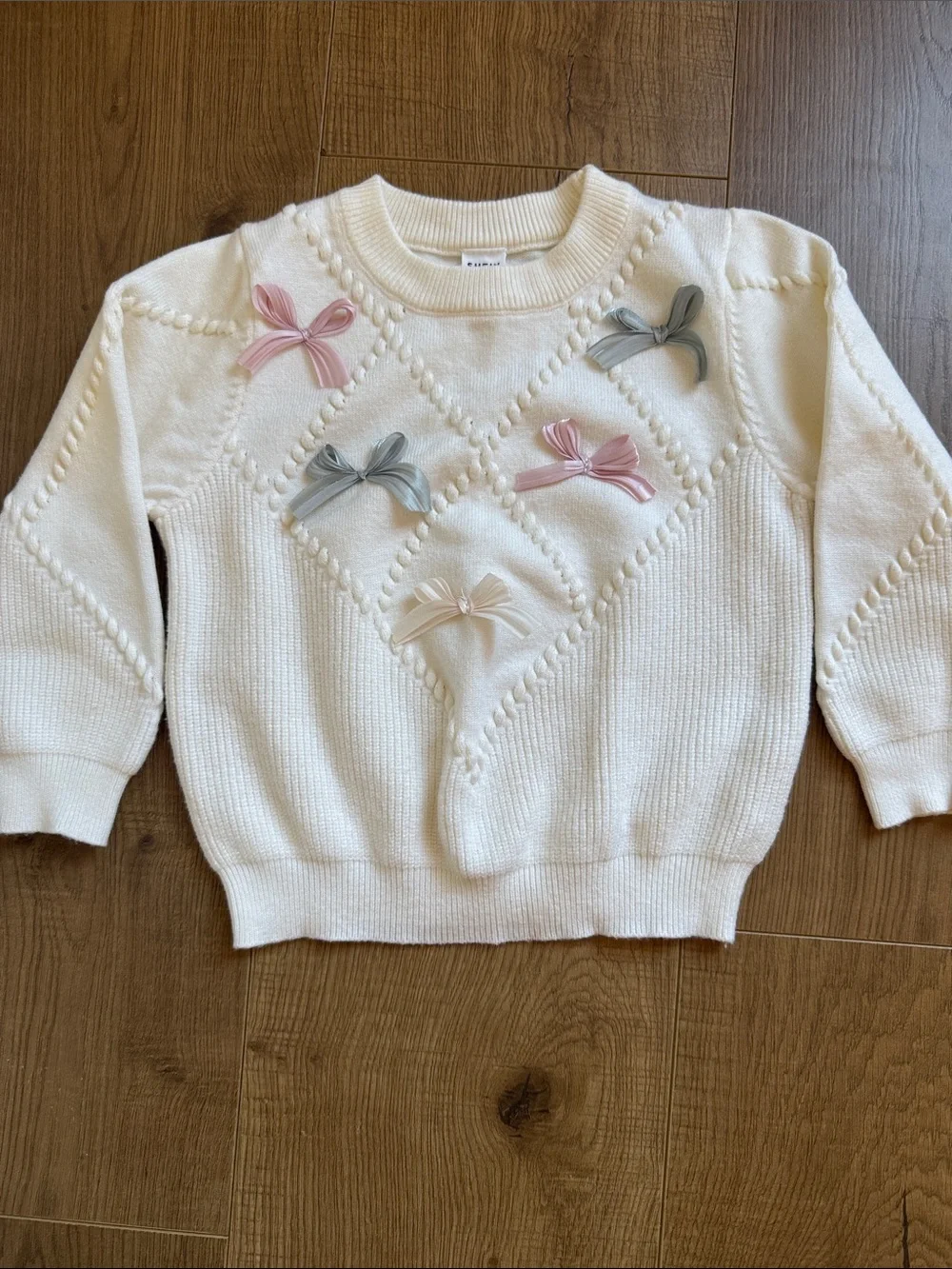 Cream Bow-Appliqué Knit Sweater with Pink Accent and Matching Pink Skirt